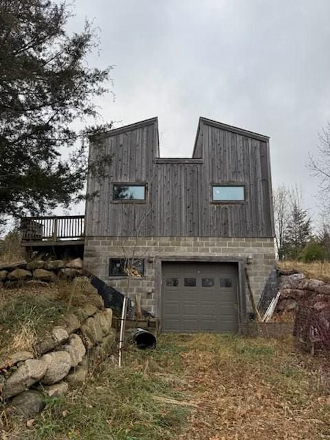 view of side of property with a garage and a wooden deck