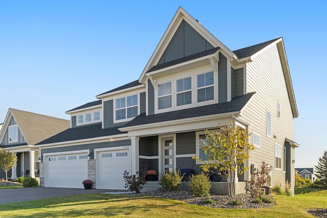 craftsman-style house featuring a front yard and a garage