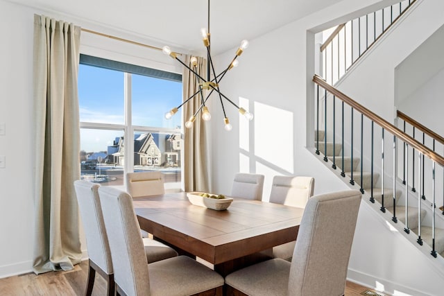 dining room featuring light hardwood / wood-style floors and an inviting chandelier