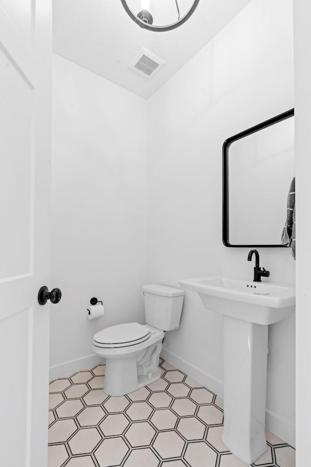 bathroom with toilet and sink