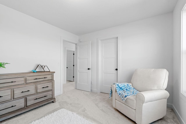 living area featuring light colored carpet