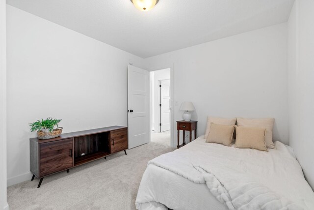 bedroom featuring light colored carpet