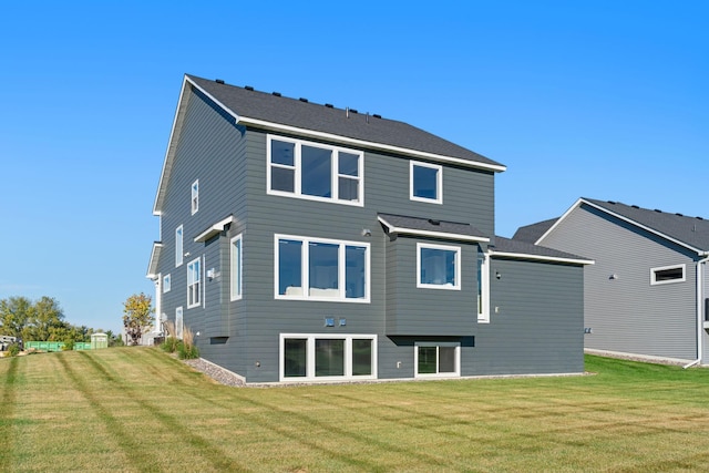 rear view of house with a yard