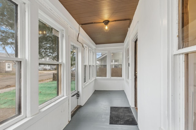 unfurnished sunroom with wooden ceiling