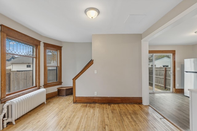 spare room with light hardwood / wood-style floors and radiator