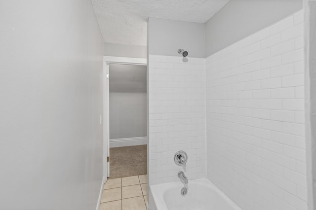 bathroom featuring a textured ceiling, tile patterned floors, and tiled shower / bath