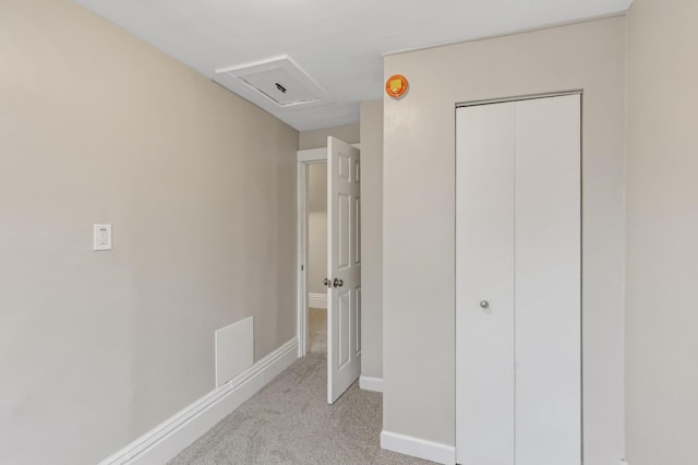 interior space with light carpet and a closet