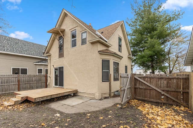 back of property featuring a wooden deck