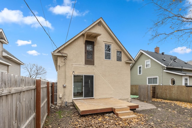 back of house featuring a wooden deck