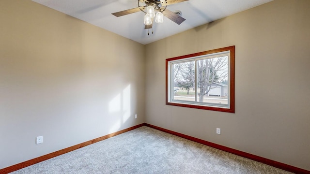 empty room featuring ceiling fan, baseboards, and carpet flooring