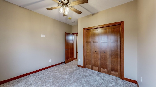 unfurnished bedroom featuring ceiling fan, a closet, carpet flooring, and baseboards