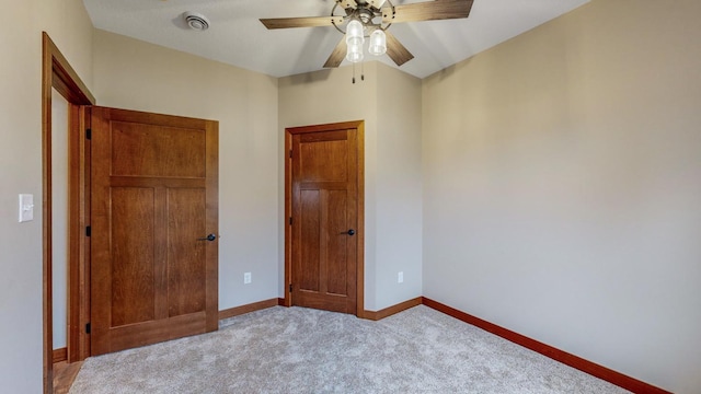 unfurnished bedroom with carpet, baseboards, and a ceiling fan