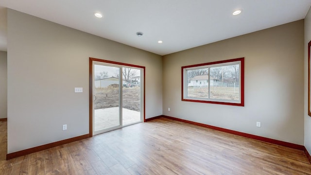 unfurnished room featuring recessed lighting, baseboards, and wood finished floors