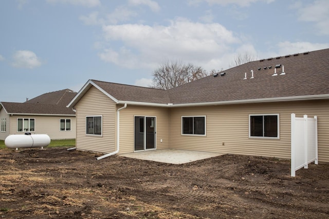 back of house with a patio area and a shingled roof