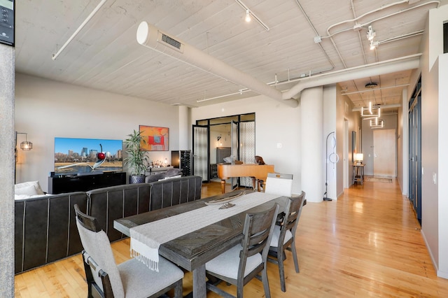 dining room featuring light hardwood / wood-style flooring and rail lighting