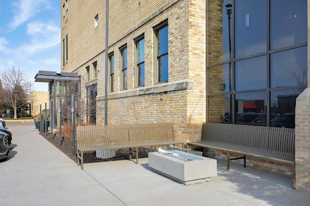 view of property exterior with a fire pit