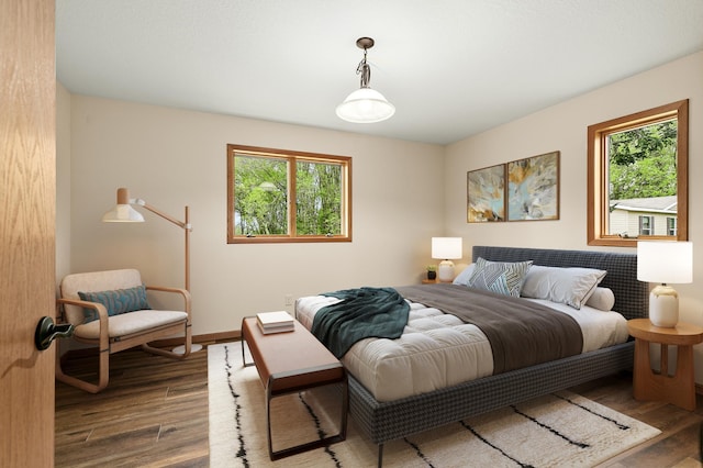 bedroom featuring wood-type flooring and multiple windows