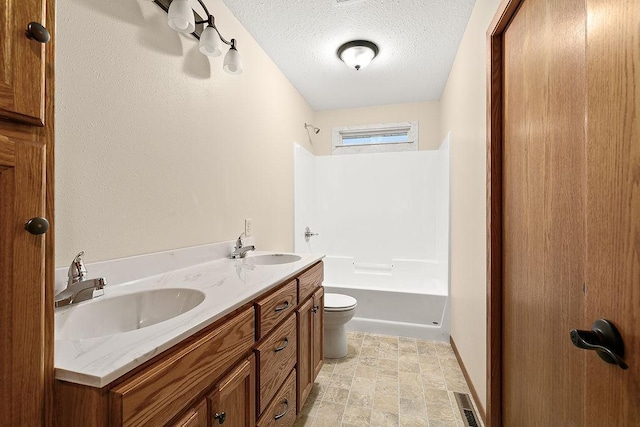 full bathroom with vanity, shower / bathing tub combination, a textured ceiling, and toilet