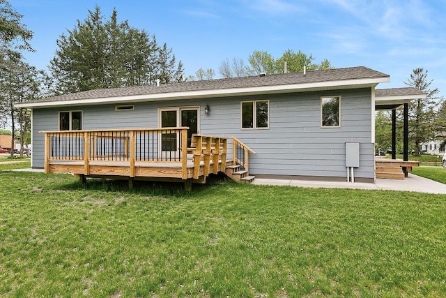 rear view of house with a lawn and a wooden deck