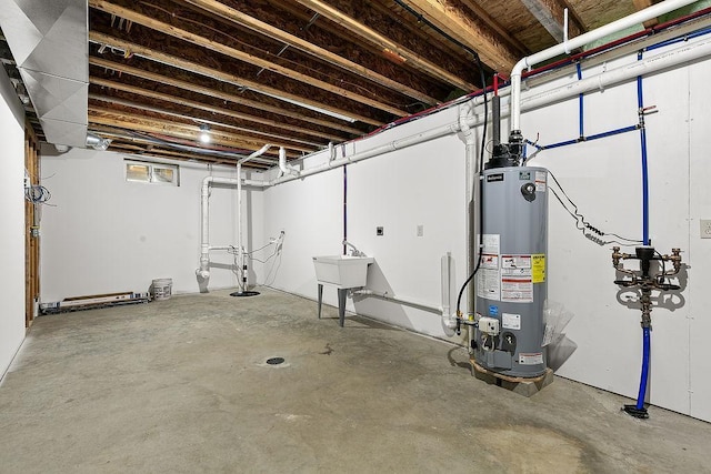 basement featuring water heater and a sink
