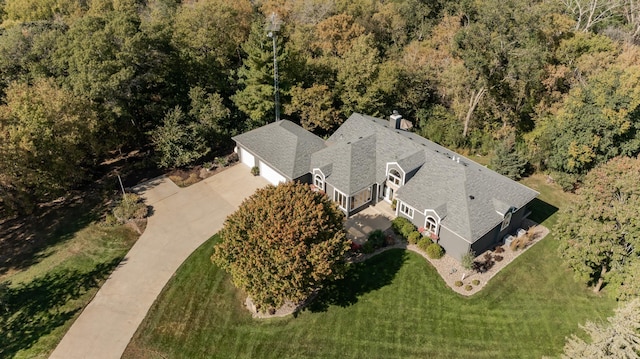 birds eye view of property with a view of trees