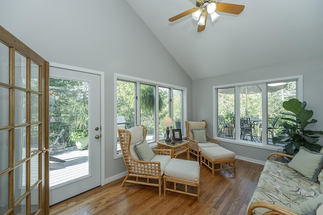 sunroom / solarium with a ceiling fan and lofted ceiling