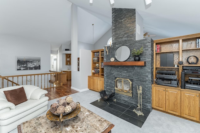 living room featuring ceiling fan, a fireplace, and high vaulted ceiling