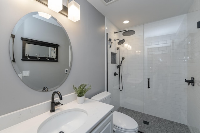 full bath featuring vanity, a shower stall, toilet, and recessed lighting