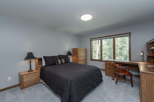 bedroom with light carpet and baseboards