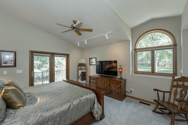 bedroom featuring visible vents, light colored carpet, access to exterior, vaulted ceiling, and multiple windows