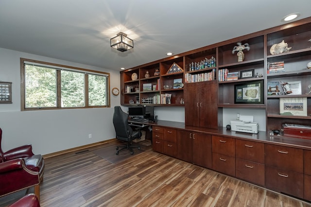 office space with recessed lighting, dark wood-style flooring, and baseboards