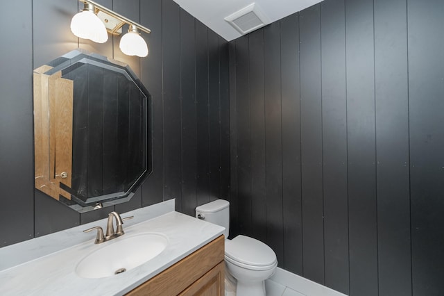 bathroom with visible vents, vanity, and toilet