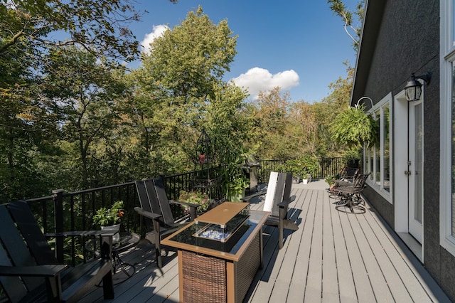 deck with a fire pit and outdoor dining area