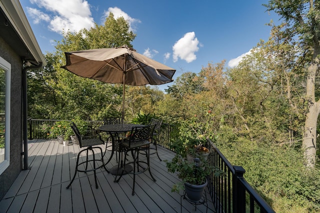 wooden deck featuring outdoor dining area