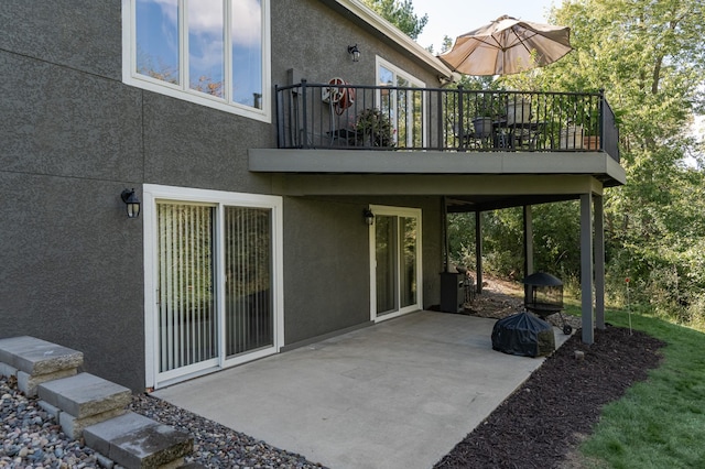 back of property with a patio area and stucco siding