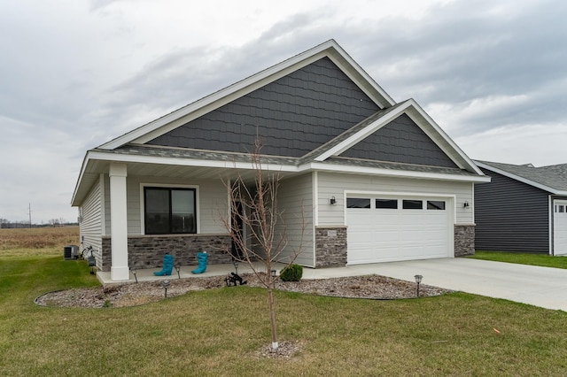 craftsman-style house with cooling unit, a front lawn, covered porch, and a garage