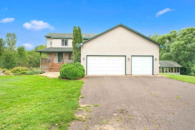 view of front of home featuring covered porch, a front yard, and a garage