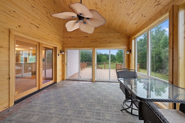 unfurnished sunroom with ceiling fan, wood ceiling, and lofted ceiling