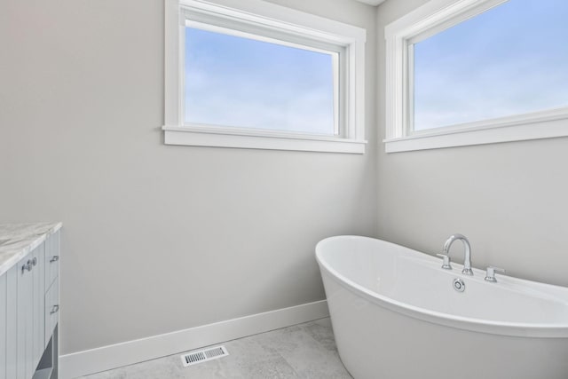 bathroom featuring a tub and vanity