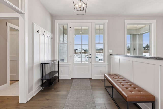 mudroom featuring dark wood-type flooring and an inviting chandelier