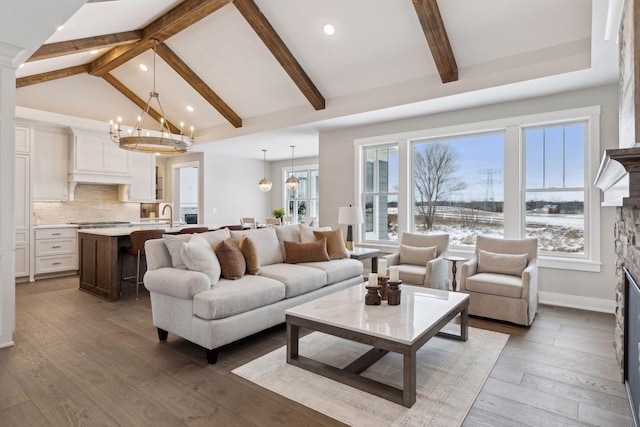 living room featuring a fireplace, dark hardwood / wood-style floors, a notable chandelier, high vaulted ceiling, and beam ceiling