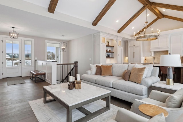 living room featuring dark wood-type flooring, a chandelier, high vaulted ceiling, and beamed ceiling