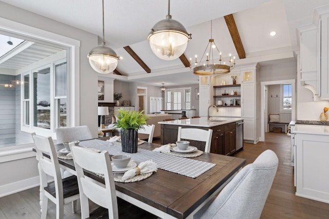 dining space with dark wood-type flooring, sink, lofted ceiling with beams, and a notable chandelier