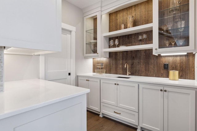 bar with sink, white cabinetry, and dark hardwood / wood-style floors