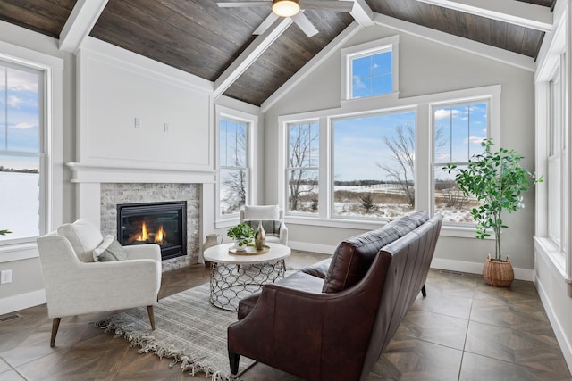 sunroom with ceiling fan, a fireplace, wooden ceiling, and lofted ceiling with beams