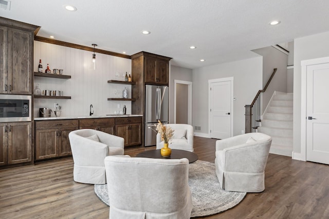 dining room with sink, wood-type flooring, and a textured ceiling