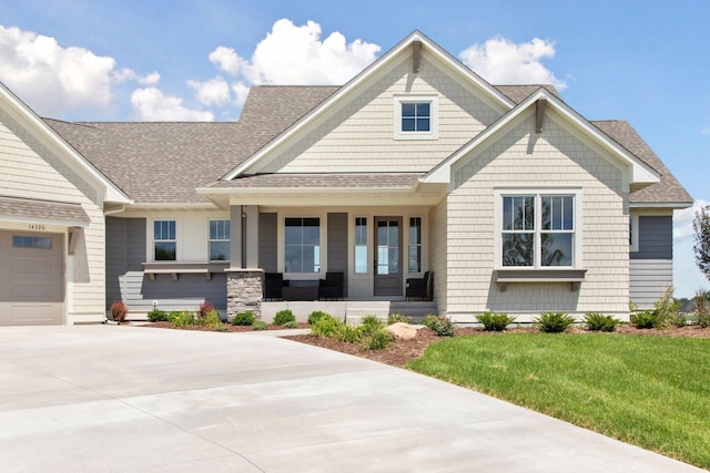 14320 47th St N, Stillwater, MN 55082 - craftsman inspired home with a shingled roof, driveway, a porch, and a front lawn