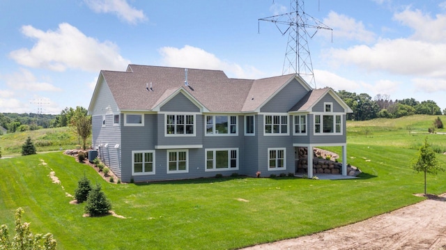 14320 47th St N, Stillwater, MN 55082 - rear view of house with a yard, a shingled roof, and a patio area