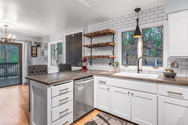 kitchen with white cabinets, sink, pendant lighting, light hardwood / wood-style flooring, and dishwasher