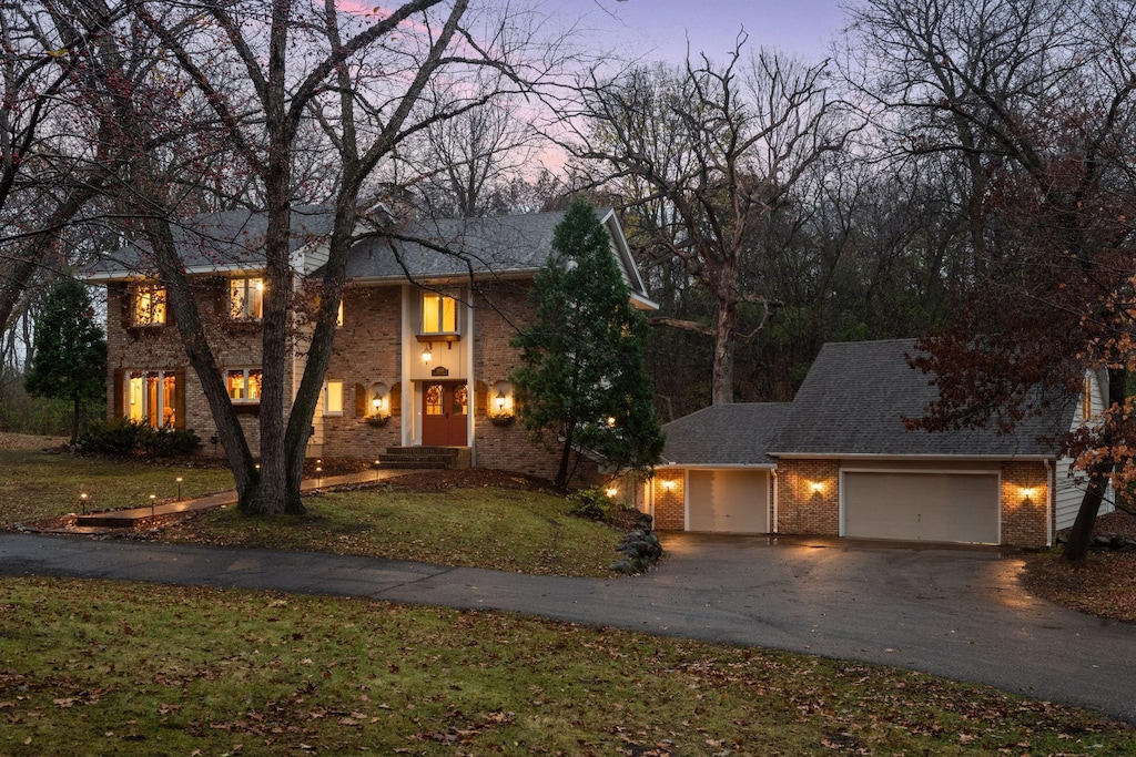 view of front of home with a yard and a garage